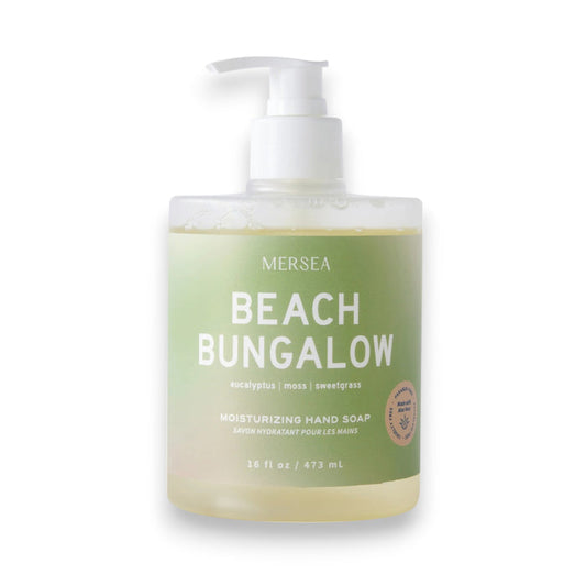 A 16oz MERSEA Beach Bungalow Hand Soap with pump dispenser features eucalyptus, moss, and sweetgrass scents, sea minerals, and a green label.