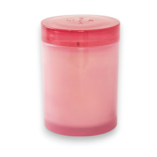 The MERSEA Cabana Flower Jolie Jar Candle features a pink cylindrical design in a translucent container with a matching lid, infused with soothing Ylang Ylang, and shown against a white background.