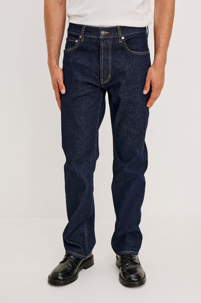 Nash Straight Leg Jean With Classic 5-Pockets, Zip Fly, and Belt Loops in Rise Wash Colorway - Lower Body Front View Featured on Model