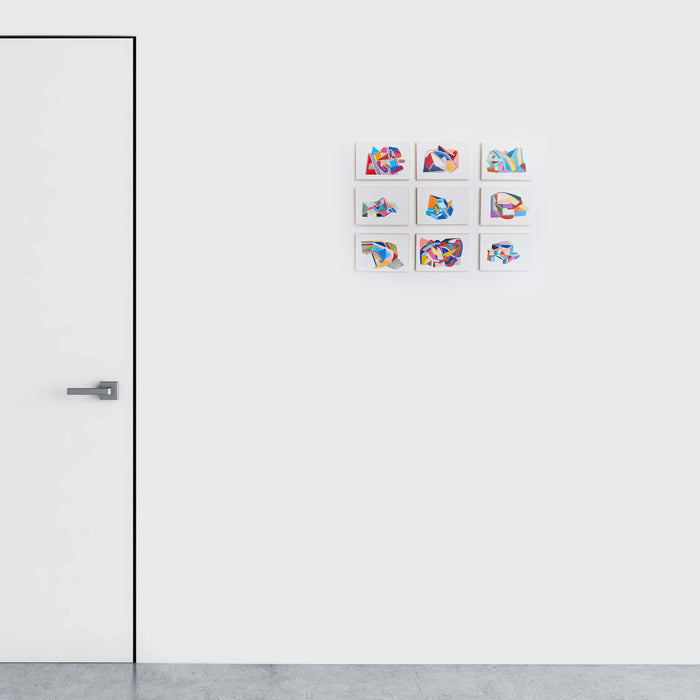 The artwork 'Nine Small Works' by Sasha Hallock features a grid of nine abstract miniature paintings arranged on a white wall. Each piece showcases vibrant geometric shapes in blue, red, and pastel hues, creating a cohesive collection. The artworks display dynamic compositions with fluid forms and bold color contrasts, mounted in a perfect 3x3 arrangement measuring 17x23 inches overall.