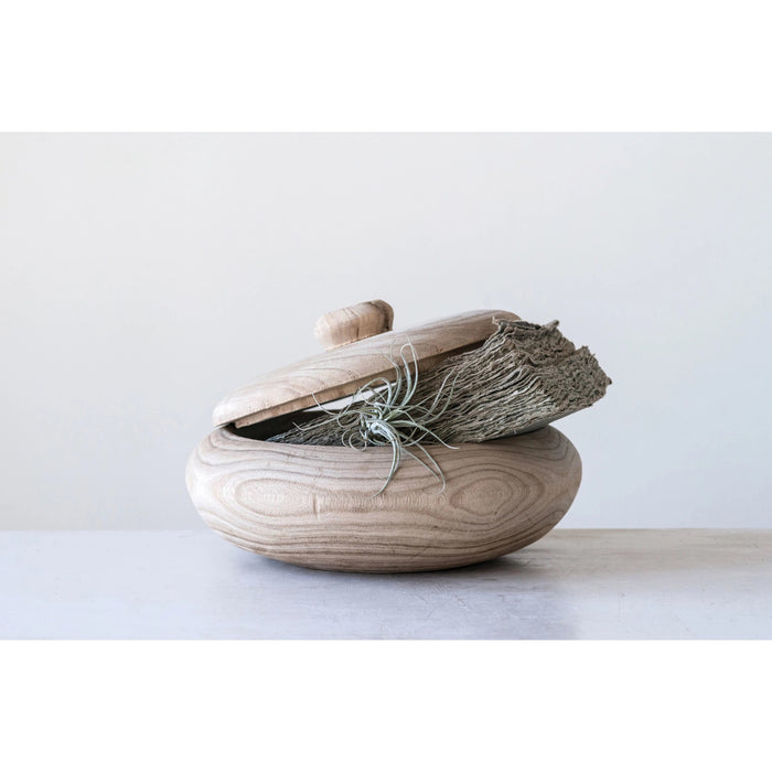 The PAULOWNIA WOOD CONTAINER by CREATIVE COOP is a round, light-colored wood container with a matching lid, slightly open to show its smooth, natural-finish interior.