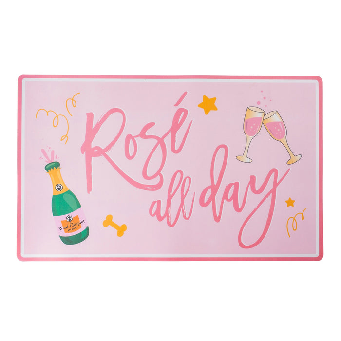 The HAUTE DIGGITY DOG PLACEMAT ROSE ALL DAY features a sparkling wine bottle, two clinking glasses of rosé, and confetti accents—stylish, easy to clean, and perfect for any celebration.