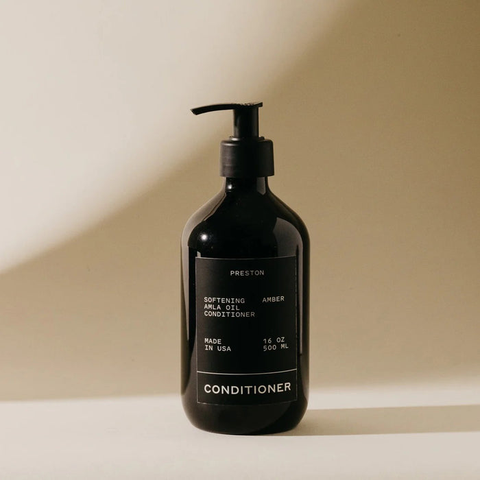 A black pump bottle labeled "PRESTON - CONDITIONER" by PRESTON (16 oz / 500 ml, Made in USA) sits on a beige background, highlighting its nourishing formula for aniline leather.