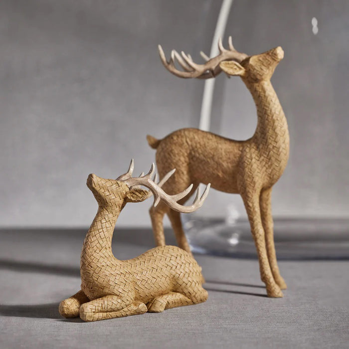 The ZODAX RATTAN STANDING DEER is a woven wicker figurine with a light brown body and white antlers, standing on four legs and looking upward. It measures 8.25 in x 13 in (20.96 cm x 33.02 cm) against a plain white background.