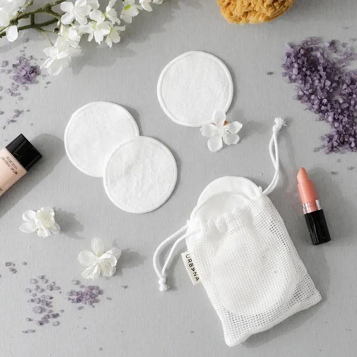 A set of REUSABLE FACE PADS from EUROPEAN SOAPS, LLC, perfect for your skin care routine. The image shows two white, round face pads and a white drawstring mesh bag with a tag that reads "REUSABLE FACE PADS, Spa Prive." An ideal travel companion for staying refreshed on the go.