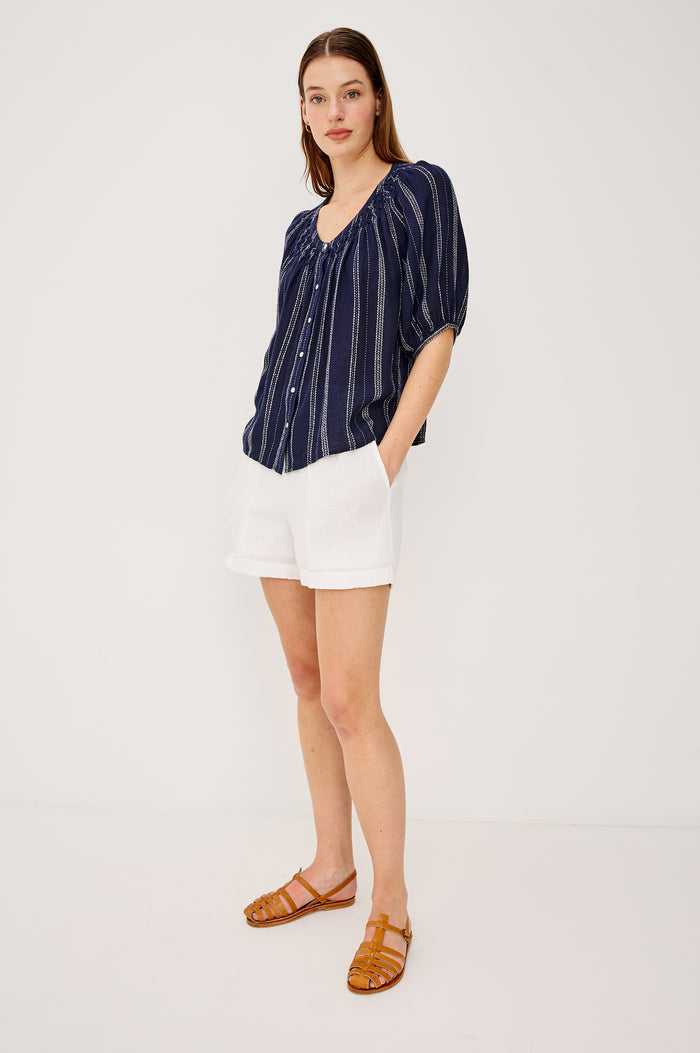 Rix Top in Linen With Scoop Neckline Relaxed Fit Smocked Yoke Elbow-Length Raglan Sleeves and Front Buttons in Marina Stripe Colorway - Upper Body Front View Featured on Model