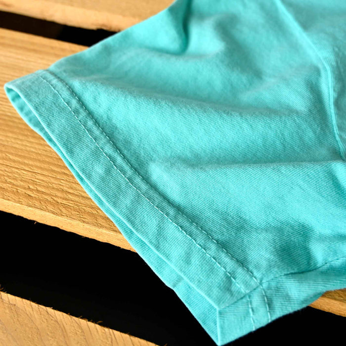 Turquoise fabric on a wooden surface
