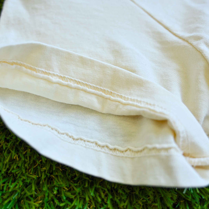 Close-up of a white fabric garment on green grass