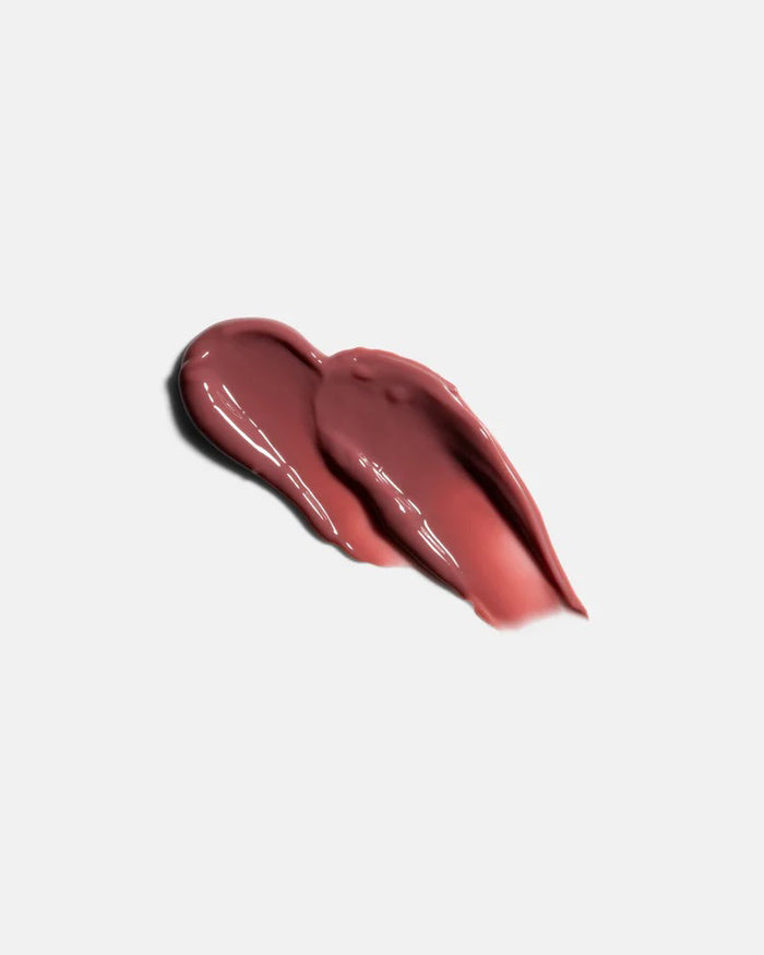 A light gray tube of U BEAUTY THE PLASMA LIP COMPOUND 15ML stands upright with white text and logo, highlighting this hydrating lip treatment and plumper against a white background.