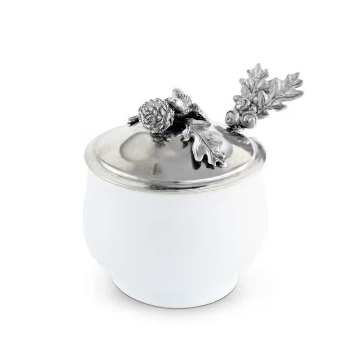 The VAGABOND HOUSE - ACORN OAK LEAF SUGAR BOWL is a white porcelain and pewter container with a silver lid, topped with detailed metal oak leaves and acorns—perfect for adding lodge style charm to your Antler Creamer Set.