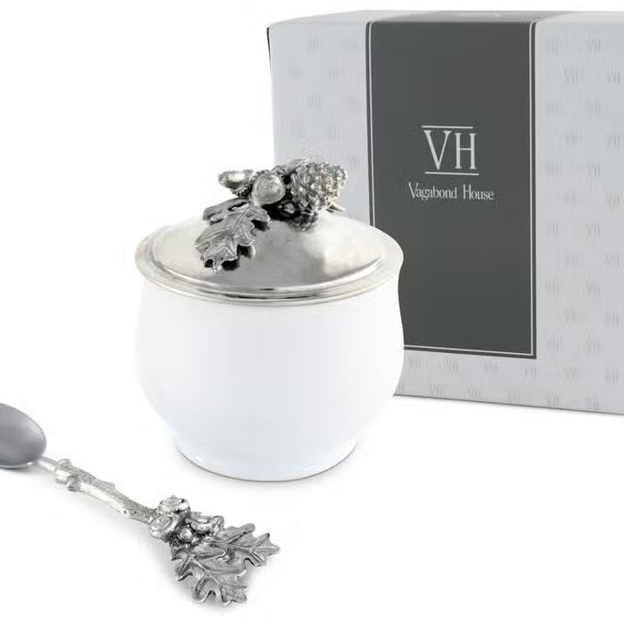 The VAGABOND HOUSE - ACORN OAK LEAF SUGAR BOWL is a white porcelain and pewter container with a silver lid, topped with detailed metal oak leaves and acorns—perfect for adding lodge style charm to your Antler Creamer Set.