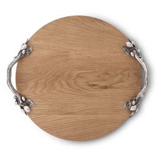 The VAGABOND HOUSE - OLIVE GROVE CHEESE BOARD is a round oak wood board with two ornate silver handles featuring leaf and berry accents, shown from above on a white background.