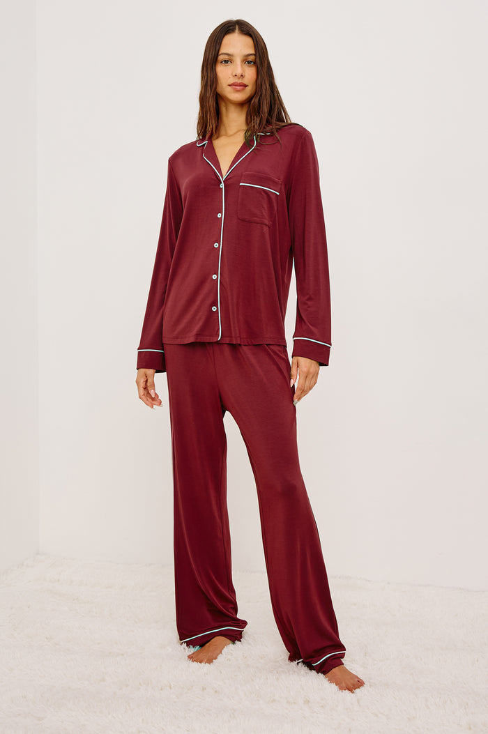 Varra Pajama Set in Jersey With Contrast Piping Button-Up Shirt With Notched Collar and Long Sleeves and Matching High-Waisted Pants With Adjustable Waist Drawstring Ties in Loose Fit in Cabernet Colorway - Full Body Front View Featured on Model