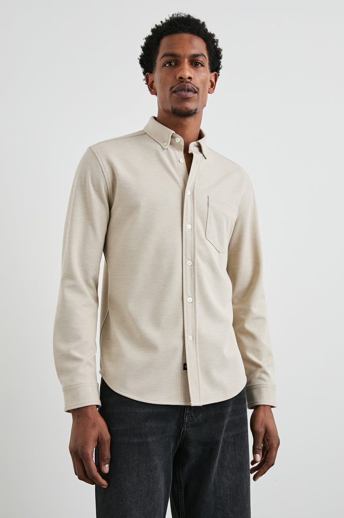 Vincent long sleeve shirt combines comfort of a knit with a buttoned classic collar. Front view of model feautured.