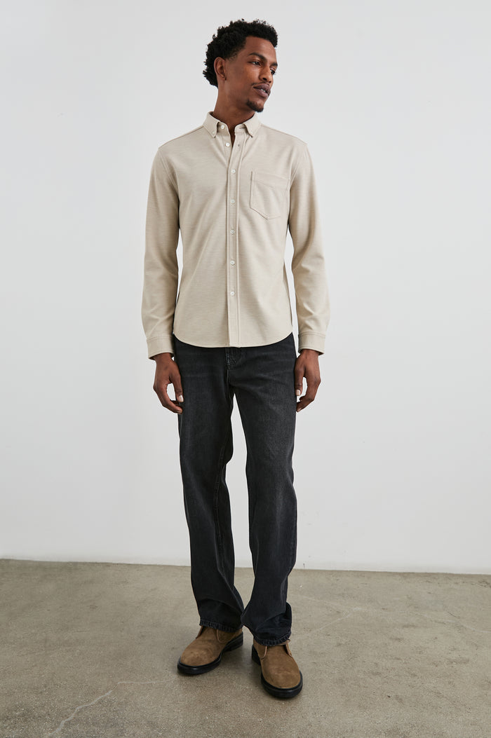 Vincent long sleeve shirt combines comfort of a knit with a buttoned classic collar. Front view of model feautured.