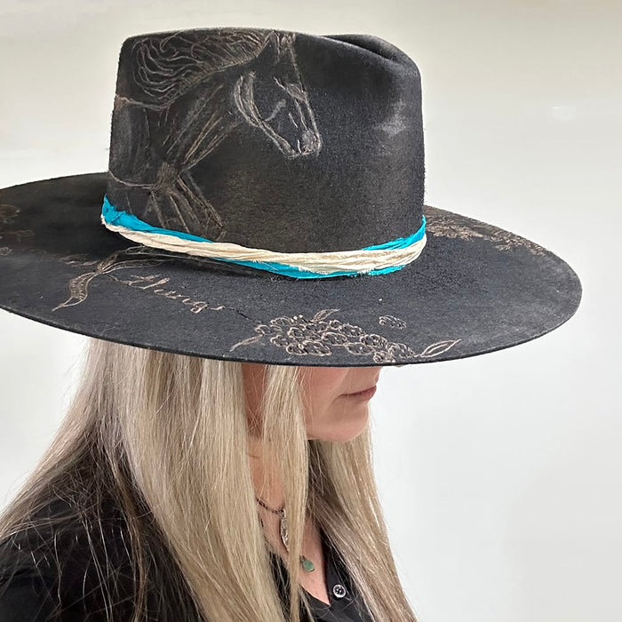 Black hat with horse design and turquoise trim