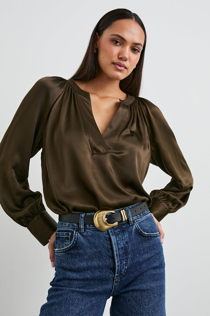 Wynna Long-Sleeve Top with a Deep V Neck and Ruching above the Cuffs and at the Neckline in Dark Moss Colorway - Front Tucked View Featured on Model