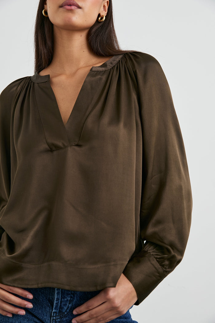 Wynna Long-Sleeve Top with a Deep V Neck and Ruching above the Cuffs and at the Neckline in Dark Moss Colorway - Front View Featured on Model