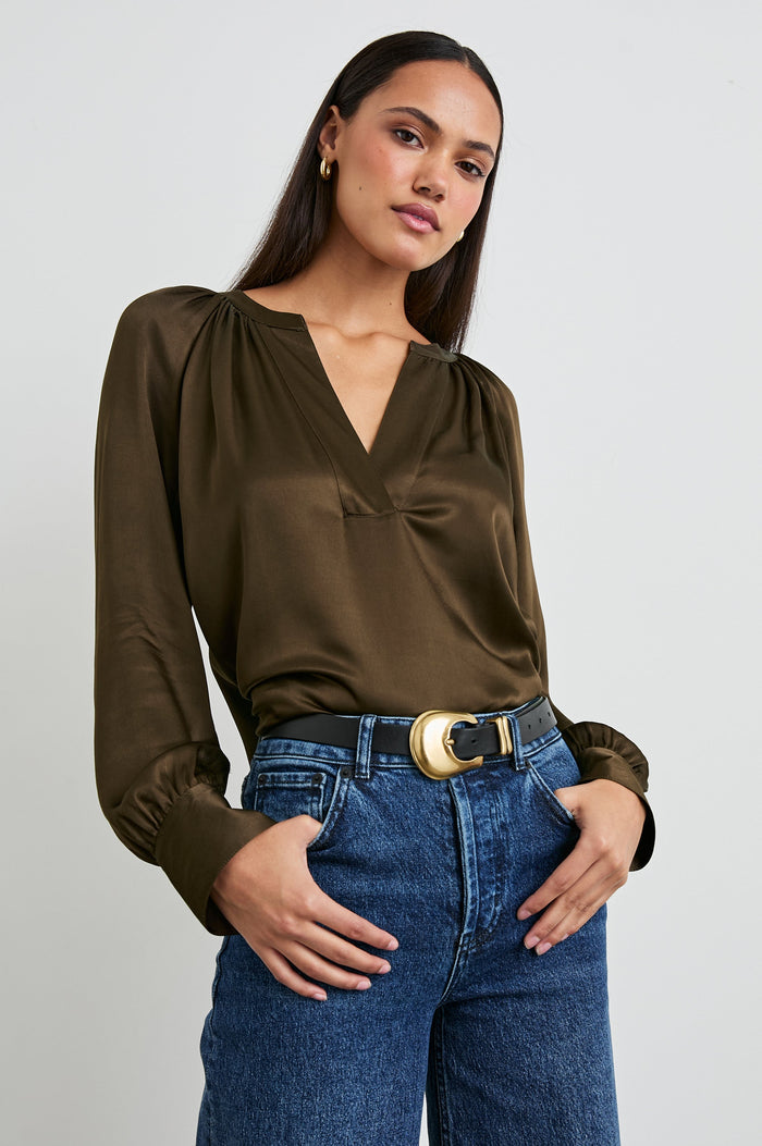 Wynna Long-Sleeve Top with a Deep V Neck and Ruching above the Cuffs and at the Neckline in Dark Moss Colorway - Front Tucked View Featured on Model