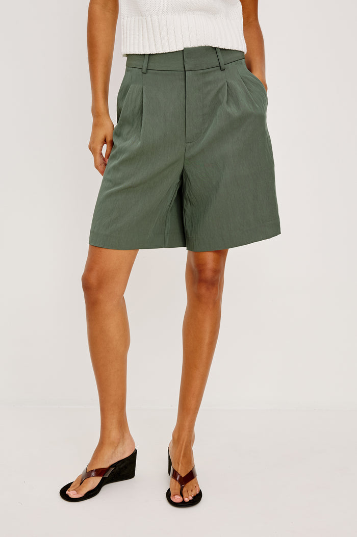 Zamora High-Waist Mid-Length Short With Front Zip Fly Belt Loops and Front Pleats in Ivy Colorway - Lower Body Front View Featured on Model