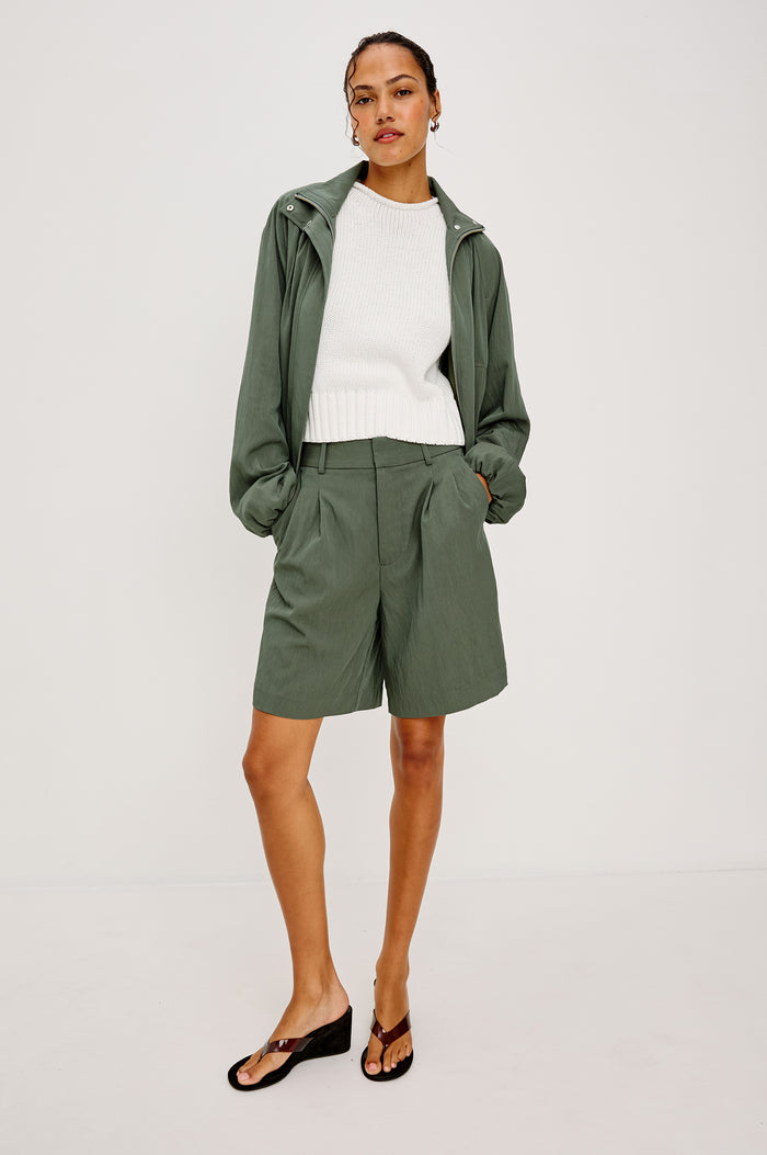 Zamora High-Waist Mid-Length Short With Front Zip Fly Belt Loops and Front Pleats in Ivy Colorway - Full Body Front View Featured on Model